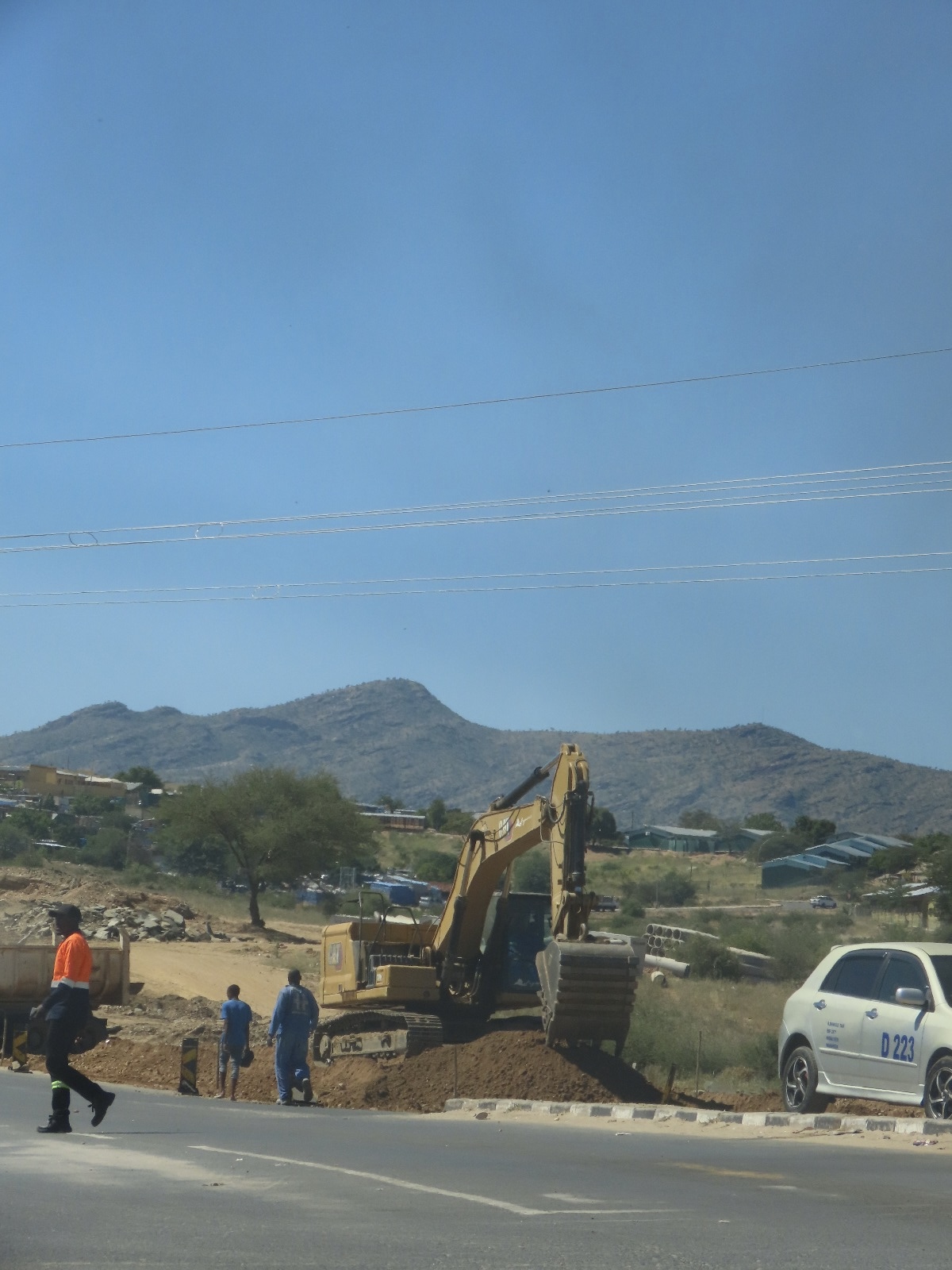 Excavator carrying out road construction work